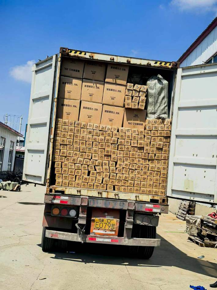 Open loaded container outside the VESTA warehouse with cartons and wrapped packages visible