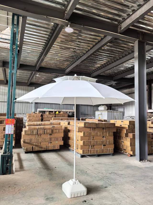 White double-layer beach umbrella with a raised upper canopy photographed at the VESTA warehouse